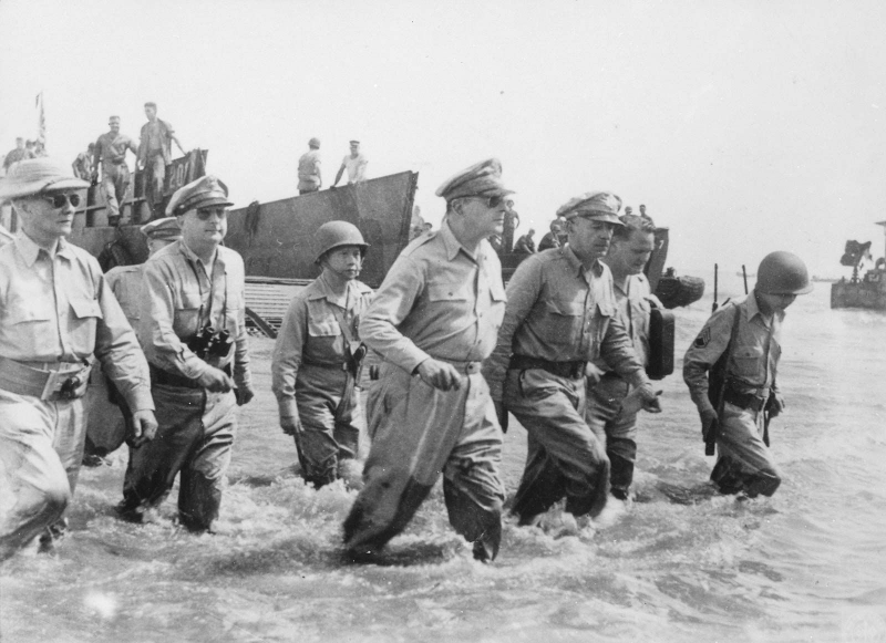 General Douglas MacArthur (center) and his entourage arriving on shore during the first U.S. landings at Leyte, Philippines, on October 20, 1944.