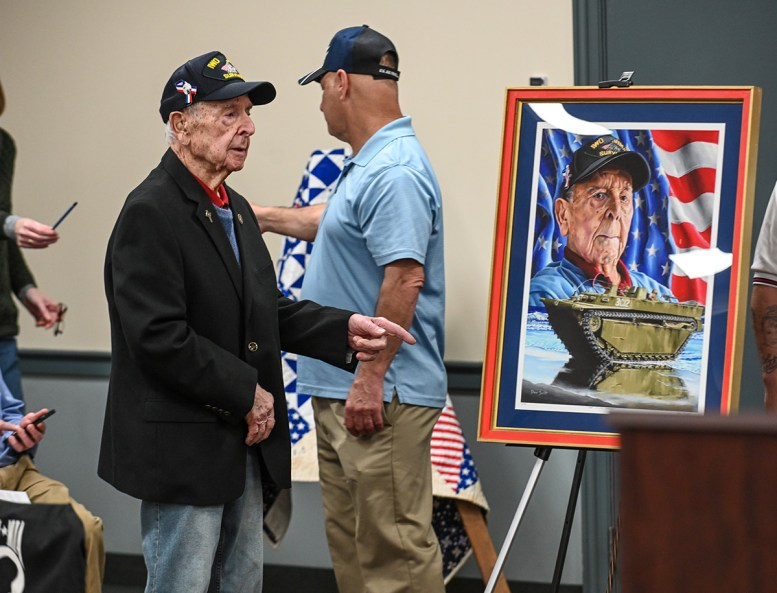 Joe Caminiti is presented with his painting